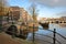 The junction between Amstel river and Prinsengracht Canal, with Skinny Bridge Magere Brug in the background