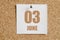 june 03. 03th day of the month, calendar date.White calendar sheet attached to brown cork board.Summer month, day of the