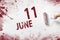 June 11st . Day 11 of month, Calendar date. The hand holds a roller with red paint and writes a calendar date on a white