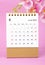 The June 2023 calendar desk and pink orchid on pink background