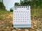 June 2023 white desk calendar on blurred nature background. Calendar concept