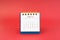 June 2024 white desk calendar on red background