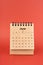 June 2024 white mini desk calendar on red background