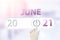 June 21st . Day 21 of month, Calendar date.Hand finger switches pointing calendar date on sunlight office background. Summer month