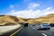June 28, 2019 Livermore / CA / USA - Cars heading towards Altamont Pass in East San Francisco bay area; wind turbines visible in