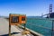 June 29, 2018 Sausalito / CA / USA - Fort Baker Fishing Pier posted regulations regarding crab fishing; Golden Gate Bridge visible