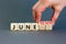 Juneteenth in June symbol. Concept words Juneteenth and June on wooden cubes. Beautiful grey table grey background. Businessman