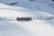 Jungfraujoch train passing snow trail at Kleine Scheidegg Station - Wengen, Switzerland