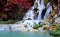 The jungle with Atumn trees fall as a waterfall-river-rocks-covered-with rainy forest-Waterfall in the forest at park