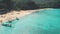 Jungle and beach with azure sea water. Palm trees, forest on mountains. Panorama coast, boat people