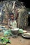 Jungle of CAR. Africa. Jungle of the Central-African Republic. Baka woman cooks food, crushing a flour in a mortar