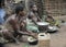 Jungle of CAR. Africa. Jungle of the Central-African Republic. Baka woman cooks food, crushing a flour in a mortar