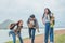 Jungle with friends. Group of young people with backpacks walking together and looking happy