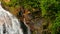 Jungle paradise landscape of tropical country. Waterfall cascade in green rain forest. Motion of water flow from cliff