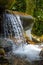 Jungle Waterfall In A Mountain River. Water Splashes Flowing From The Rocks.