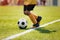 Junior afro american soccer player. Child running with soccer ball along side line