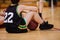 Junior basketball player sitting on the floor in basketball court