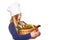 Junior cook holding a basket with vegetables