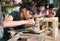 Junior craftsmen making copper handicraft products in traditional way