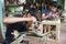 Junior craftsmen making copper handicraft products in traditional way