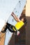 Junior female Athlete makes hard move on climbing Wall