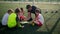 Junior football team coach shows children game scheme