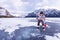 Junior Ice hockey player in outdoor action surrounded by mountains