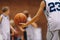 Junior level basketball player holding game ball at practice drill