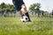 Junior Level Football Player Kicking Ball. Legs of Soccer Striker Playing Training Game