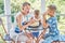 Junior school children and preschooler eating fresh melon