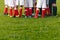 Junior Soccer Team Standing in Group. Football Grass Field and Players Feet. Soccer Stadium Grass Background