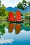 Junk. Beautiful traditional vietnamese boat with red sails on a picturesque lake in the jungle. Red sails reflected in the water.