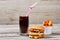 Junk food on wooden backdrop.