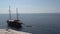 Junk sailboat with tourists sailing away in Thassos Greece