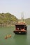 Junk towing kayaks, Halong Bay, Vietnam