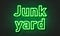 Junk yard neon sign on brick wall background.