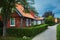 JUODKRANTE, LITHUANIA - August 18, 2019: Beautiful street with old Lithuanian traditional wooden houses. Fishermen`s village on