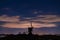 Jupiter and Saturn planets in the night sky appearing over an old Dutch windmill known as Broekmolen