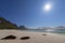 Jusnesvika Bay, seaweed dotted on the white sands of Rambergstranda beach, with the majestic mountains of Flakstadoya Island