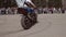 Just awesome action stunt on a motorcycle. The rider starts the race on the bike in a circle at the motor show.