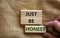 Just be honest symbol. Concept words `Just be honest` on wooden blocks on a beautiful canvas background. Businessman hand.