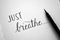 `JUST BREATHE` hand-lettered in notebook