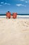 Just chill. Rearview shot of an affectionate couple reclining on their deck chairs at the waters edge.