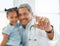 Just the cure she needed. a mature doctor holding a vaccine vial during a checkup with a little girl at home.