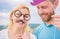 Just for fun. Humor and laugh concept. Couple posing with party props sky background. Photo booth props. Man with beard