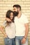 Just hang out together. Couple in love. Family couple hugging on brick wall background. Bearded man and sexy woman