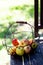 Just harvested autumn apples in the metal basket on wooden table in the garden