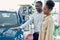 Just imagine us on the road. portrait of happy african couple checking out a car