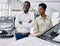 Just imagine us on the road. portrait of happy african couple checking out a car