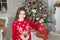 Just look at this. Christmas attributes decor. Little girl near christmas tree. Child celebrate christmas at home